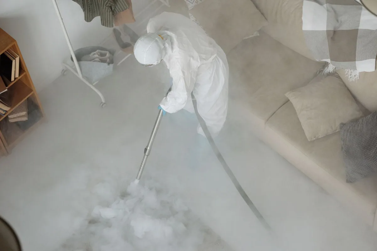 Biohazard cleanup technician in protective equipment, Ackley, IA